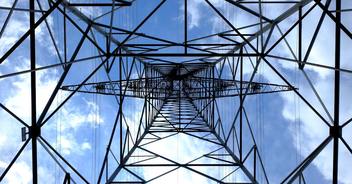 low angle photograph of black metal tower satellite during daytime