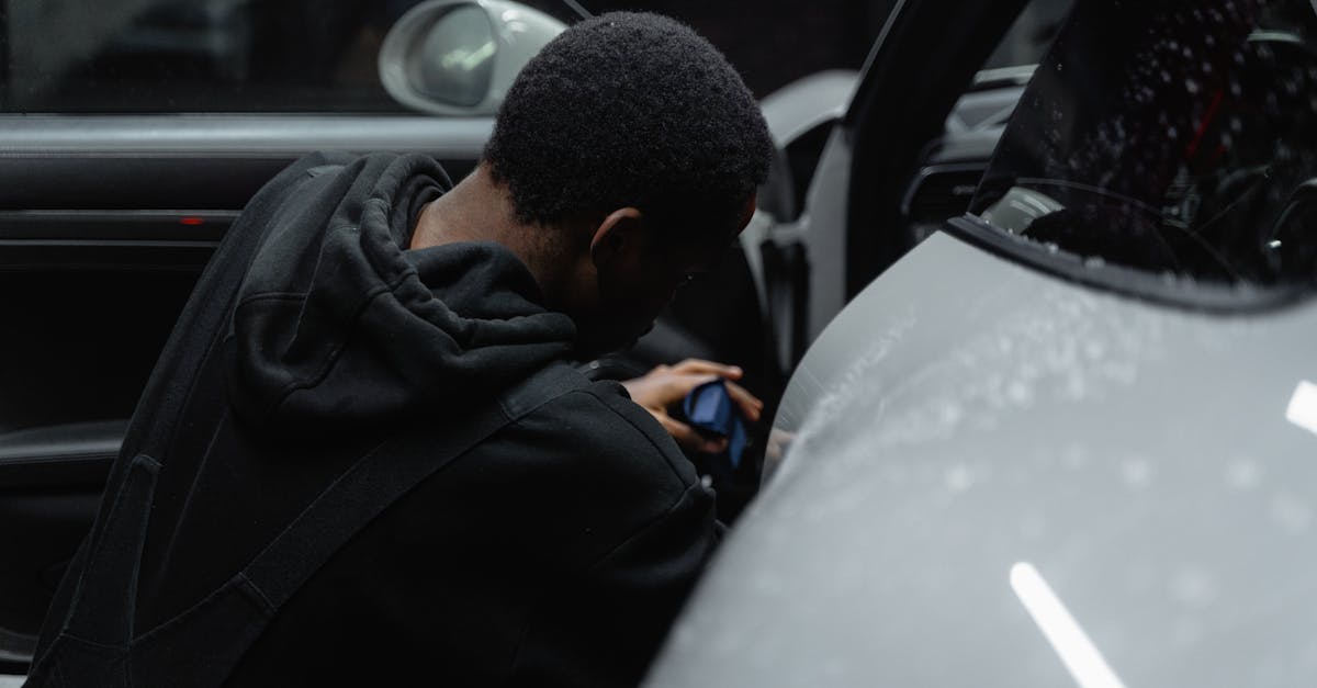 man in black jacket driving car