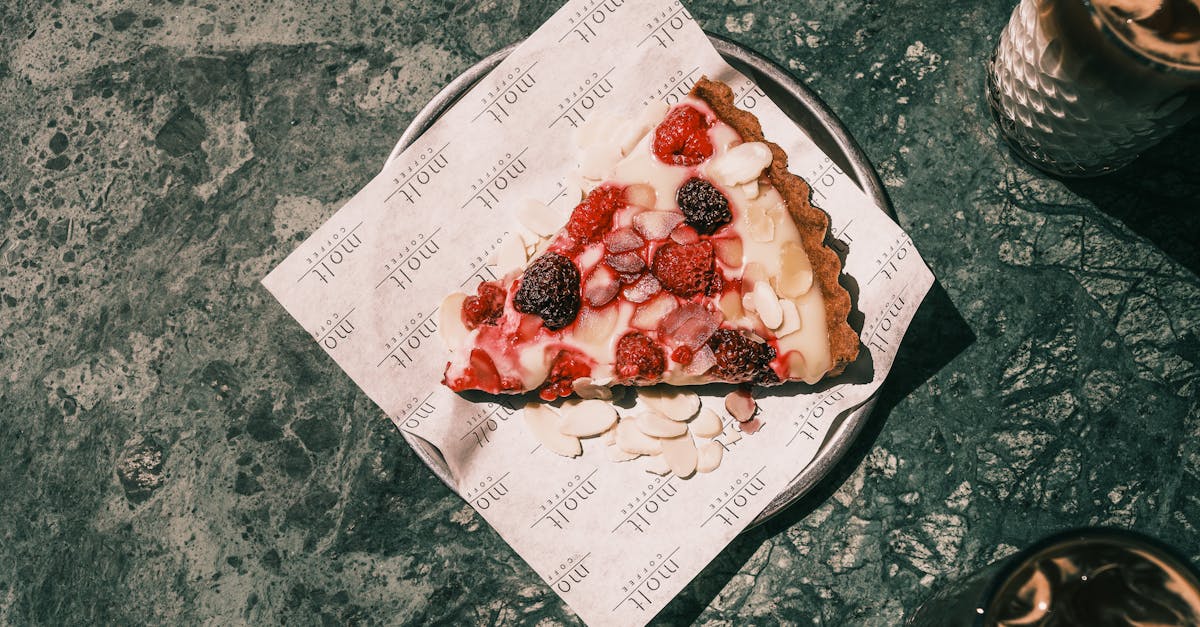 top view of a delicious berry tart slice with cream on a plate perfect for a dessert treat